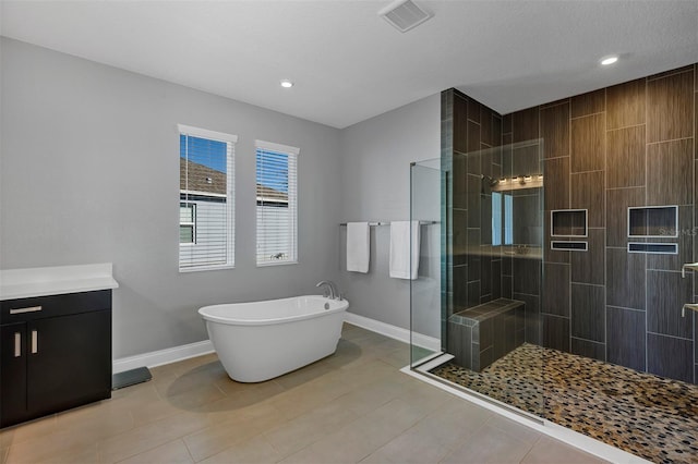 bathroom featuring separate shower and tub, tile patterned flooring, and vanity