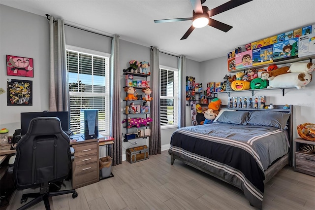 bedroom with ceiling fan and light wood-type flooring