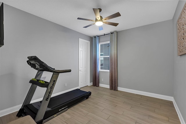 workout room with ceiling fan and light hardwood / wood-style floors