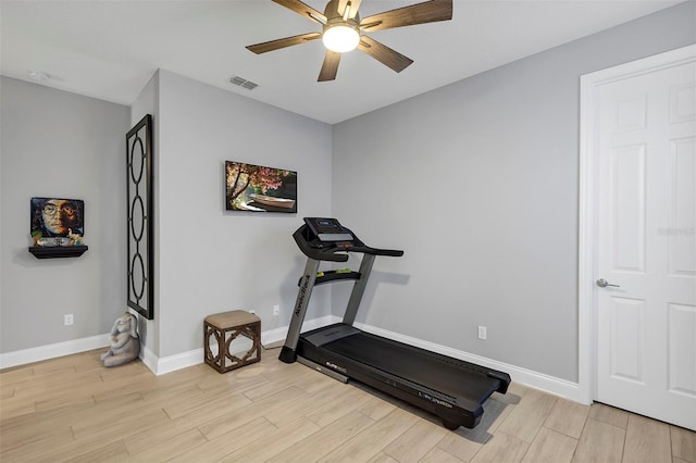 workout room with ceiling fan and light hardwood / wood-style floors