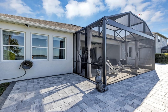 view of patio / terrace featuring glass enclosure