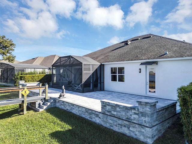 rear view of house featuring a lawn, a lanai, and a patio area