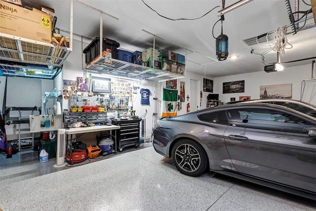 garage featuring a garage door opener and a workshop area