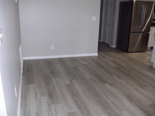 spare room with wood-type flooring