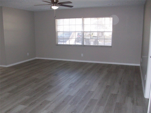 spare room featuring ceiling fan and dark hardwood / wood-style floors