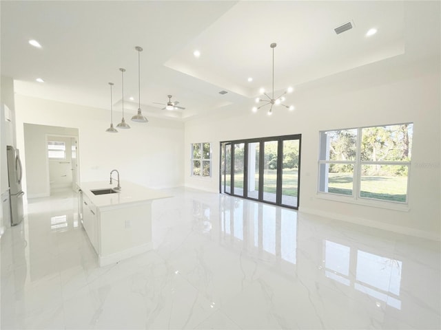 interior space with a sink, visible vents, plenty of natural light, and open floor plan