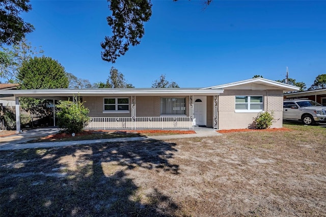 ranch-style house with a porch and a carport