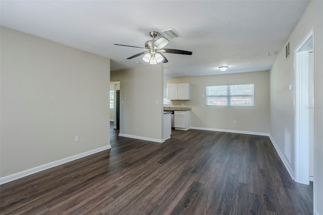 unfurnished living room with dark wood-type flooring and ceiling fan