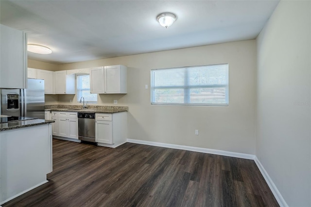 kitchen featuring white cabinets, appliances with stainless steel finishes, dark hardwood / wood-style flooring, and sink