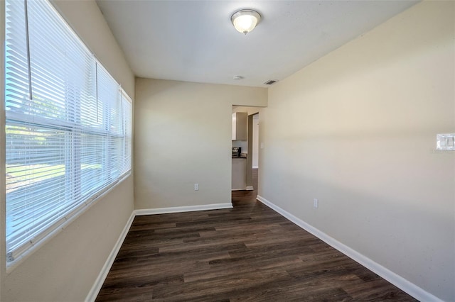 unfurnished room featuring dark wood-type flooring