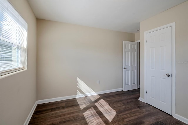 unfurnished room featuring dark hardwood / wood-style floors