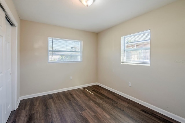 unfurnished bedroom featuring dark hardwood / wood-style floors and a closet