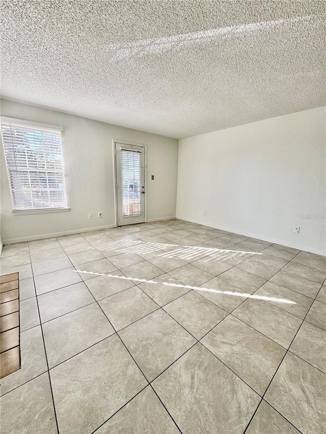 spare room featuring a wealth of natural light and a textured ceiling