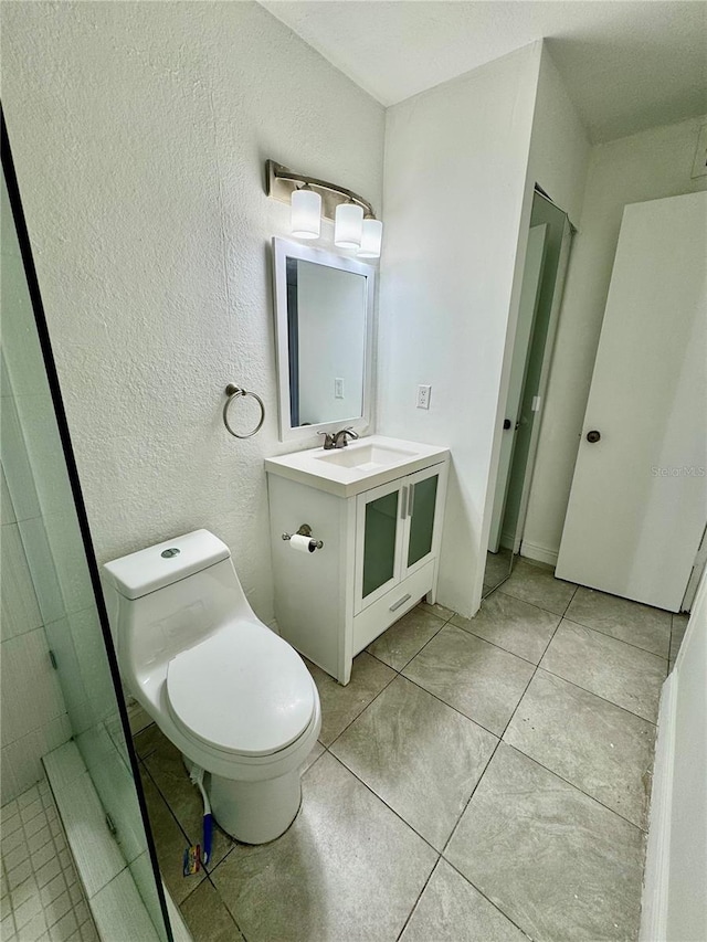 bathroom with tile patterned floors, vanity, and toilet