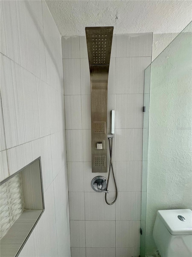 bathroom featuring toilet and a shower