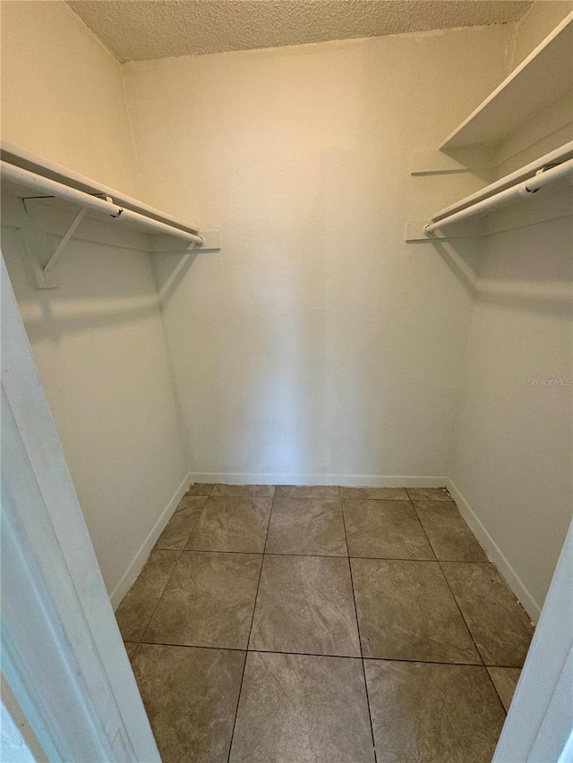 spacious closet with tile patterned flooring