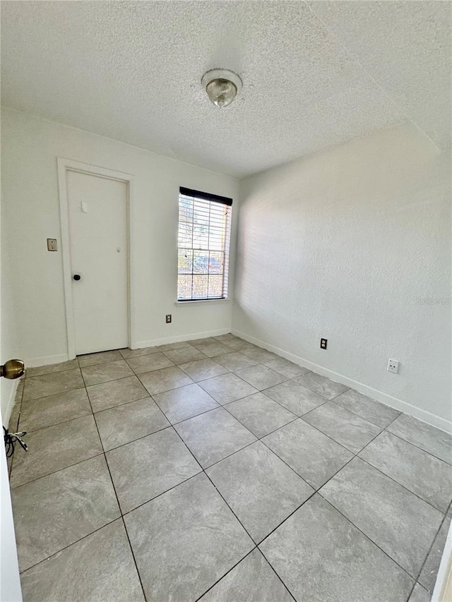 empty room with a textured ceiling