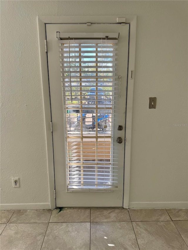 doorway with light tile patterned floors