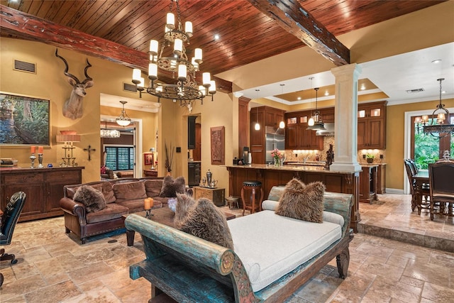 living room featuring beamed ceiling, a towering ceiling, decorative columns, and ornamental molding