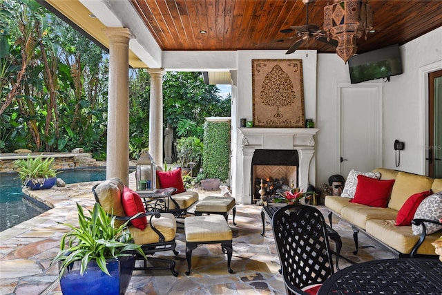 view of patio featuring an outdoor living space with a fireplace and ceiling fan