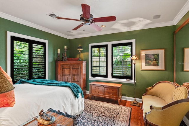 bedroom featuring hardwood / wood-style flooring, ceiling fan, and ornamental molding