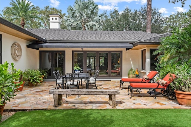 back of property with french doors and a patio