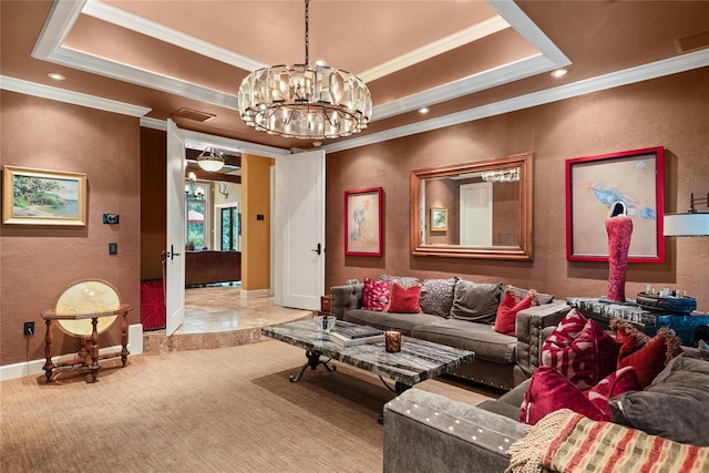 living room with a tray ceiling, crown molding, and a notable chandelier