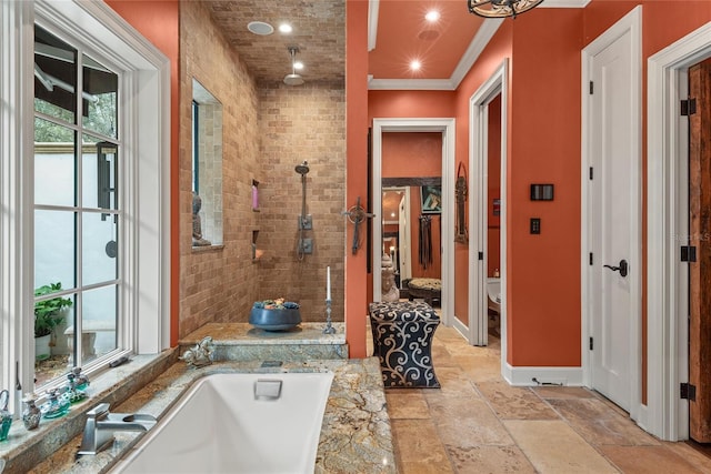 bathroom featuring ornamental molding, toilet, and a tub