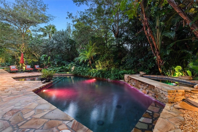 view of pool with an in ground hot tub and a patio