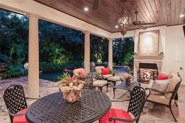 view of patio featuring an outdoor living space with a fireplace and ceiling fan