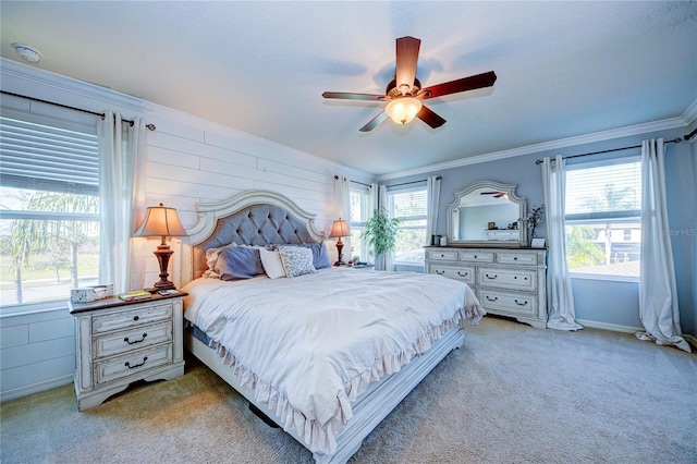 bedroom featuring ceiling fan, ornamental molding, and light carpet