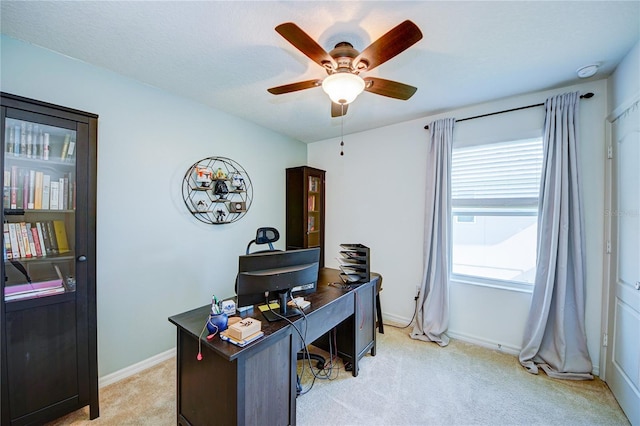 office space with light carpet and ceiling fan