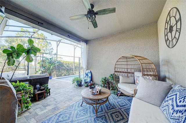 sunroom featuring ceiling fan