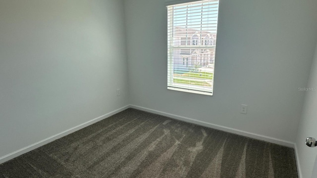 empty room with dark carpet