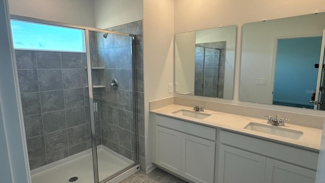 bathroom with tile patterned flooring, vanity, and a shower with door