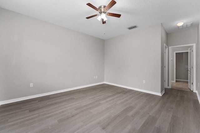 unfurnished room with a textured ceiling, hardwood / wood-style flooring, and ceiling fan