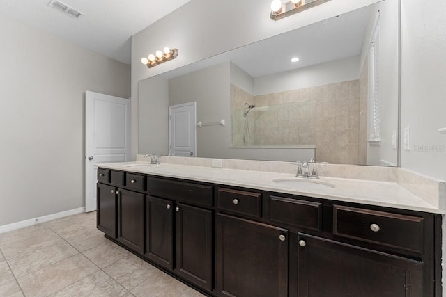 bathroom featuring a shower, vanity, and tile patterned floors