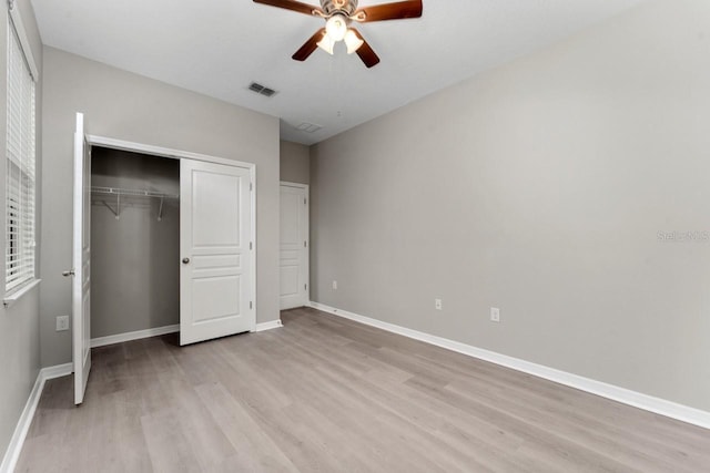 unfurnished bedroom with a closet, light hardwood / wood-style floors, and ceiling fan