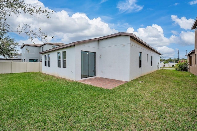 back of house with a yard and a patio area