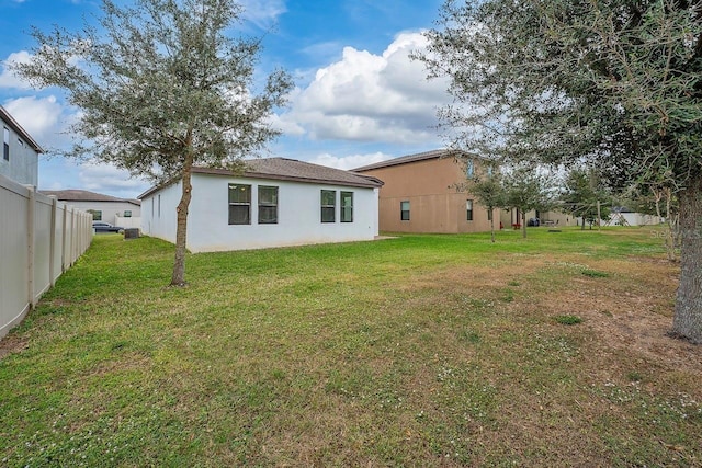 back of house with a lawn