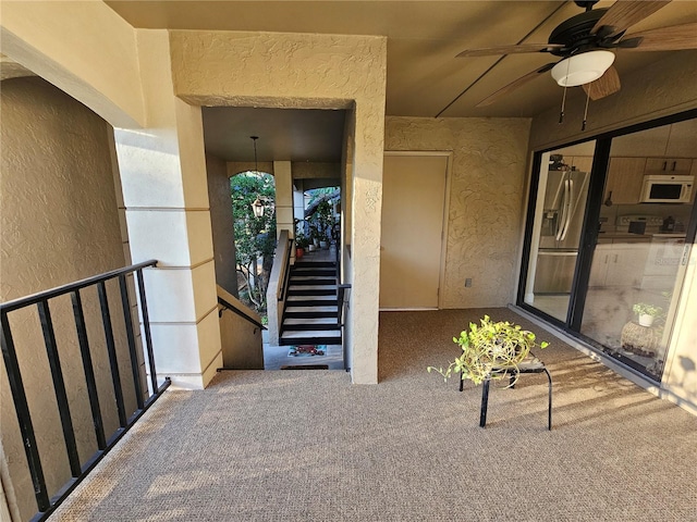 view of exterior entry featuring ceiling fan