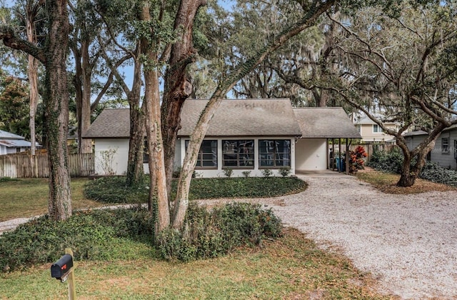 ranch-style house with a front lawn and a carport