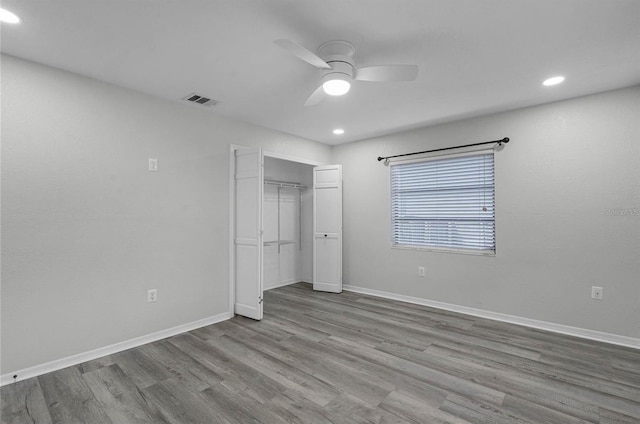 unfurnished bedroom featuring ceiling fan, a closet, and light hardwood / wood-style floors