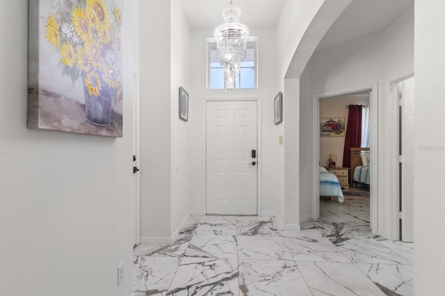 entryway with a towering ceiling and an inviting chandelier