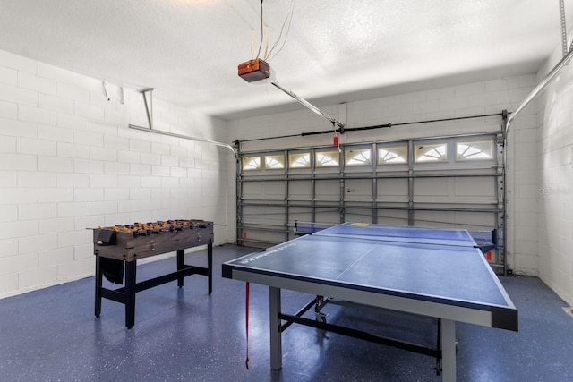 game room featuring a textured ceiling