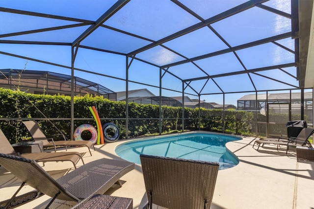 view of swimming pool featuring a lanai and a patio area