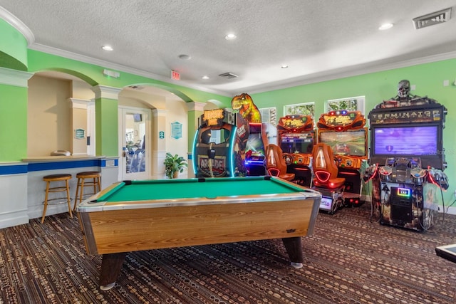 playroom with a textured ceiling, dark carpet, crown molding, and billiards