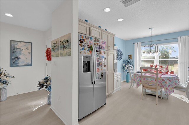 kitchen with light carpet, stainless steel refrigerator with ice dispenser, cream cabinetry, decorative light fixtures, and a chandelier