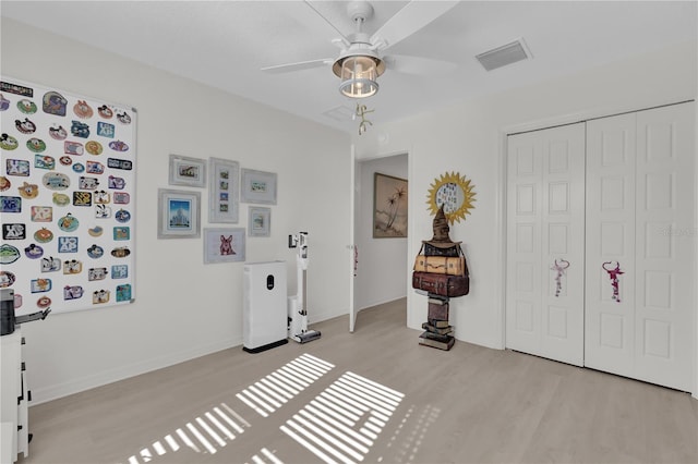 foyer with ceiling fan and light hardwood / wood-style flooring