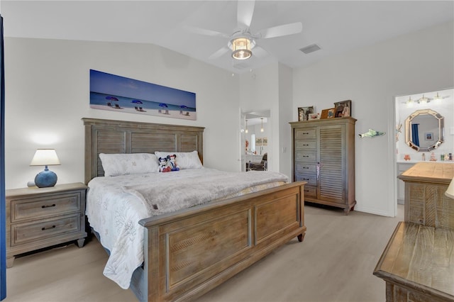 bedroom featuring ceiling fan, ensuite bathroom, and vaulted ceiling